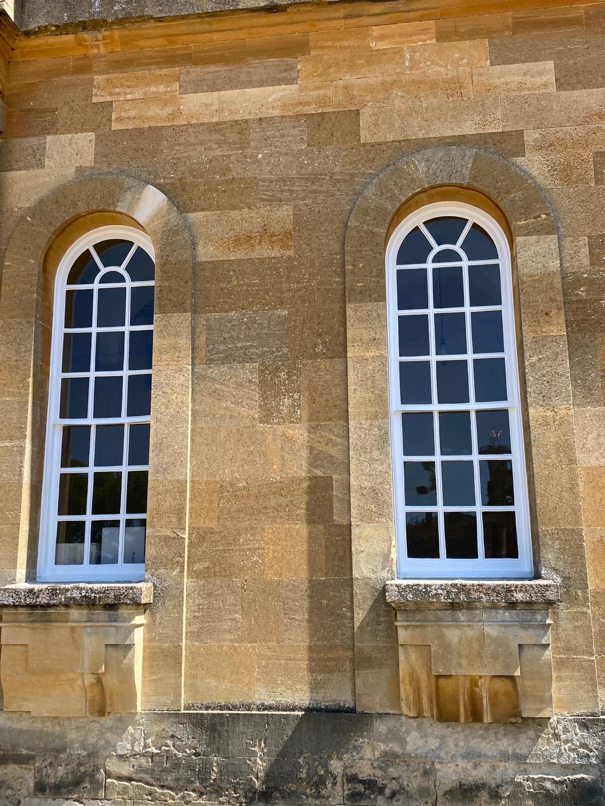 Restored arched sash windows in Cotswold stone at Blenheim Palace by Brierty Decoration