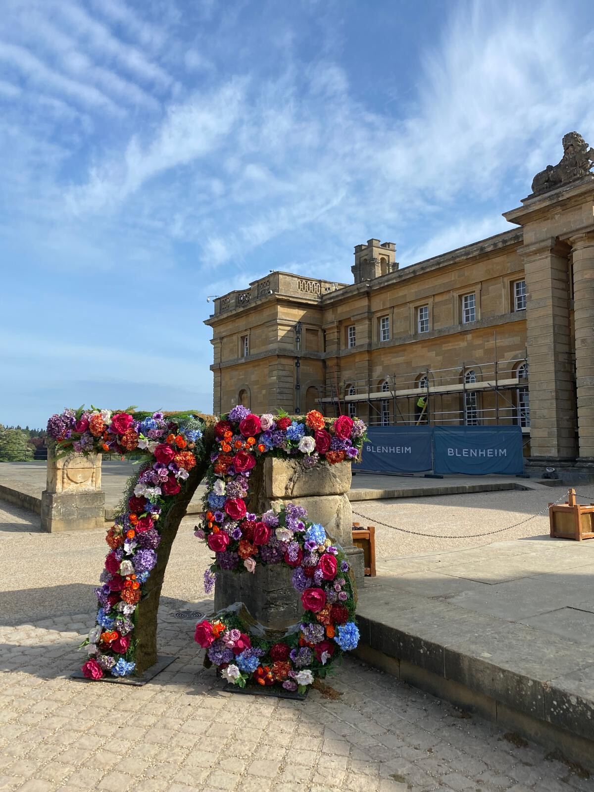 Floral display archway in front of Blenheim Palace with Brierty Decoration scaffolding works in progress