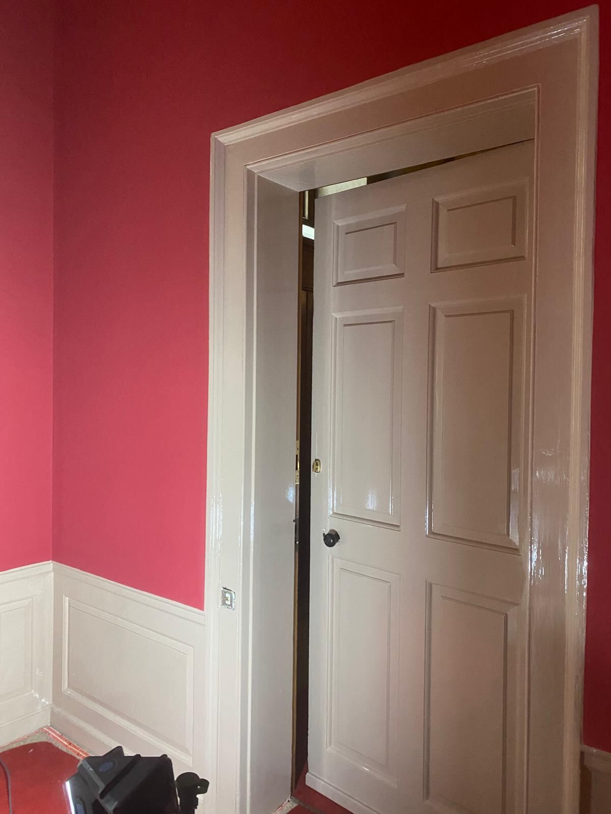 Freshly painted six-panel heritage door against deep red walls at Blenheim Palace by Brierty Decoration