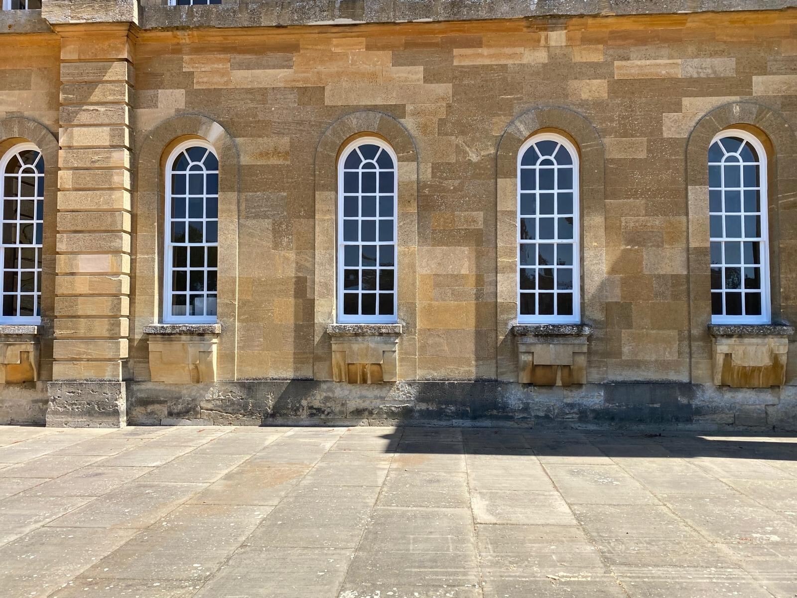Row of freshly painted arched windows on Blenheim Palace exterior, Woodstock Oxfordshire