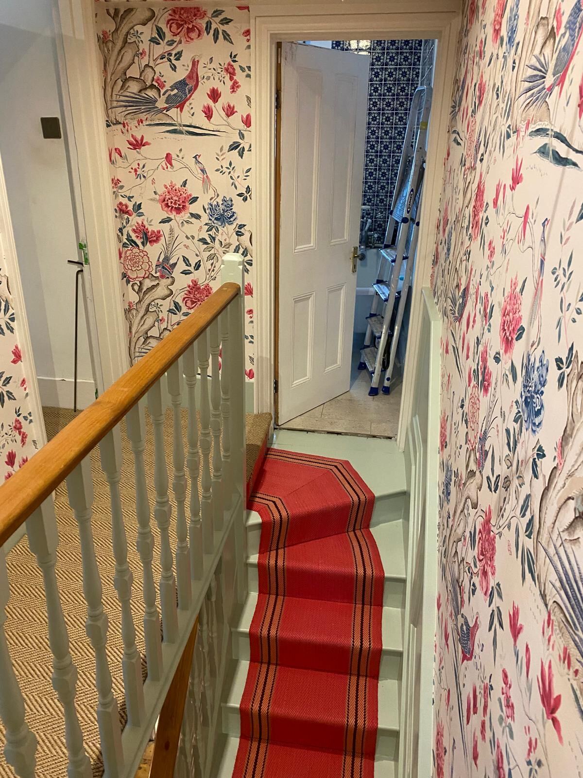 Hand-hung chinoiserie wallpaper on a Thames Valley staircase