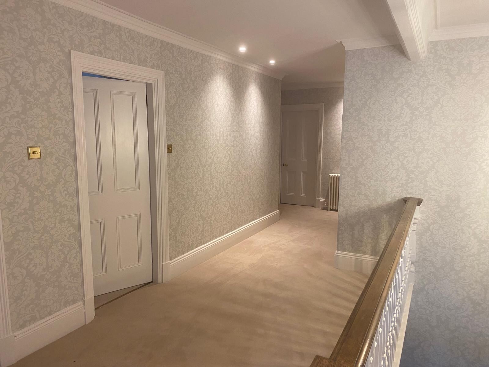 Pale grey damask wallpaper on the first-floor hallway of an Elizabeth Cleall Interiors project